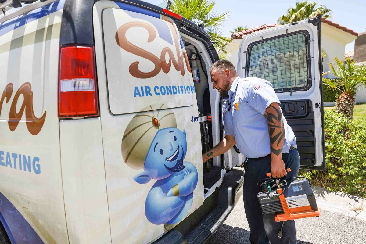Service technician with Sahara Air Conditioning & Heating Jeremy Rojas loads up his tools a ...