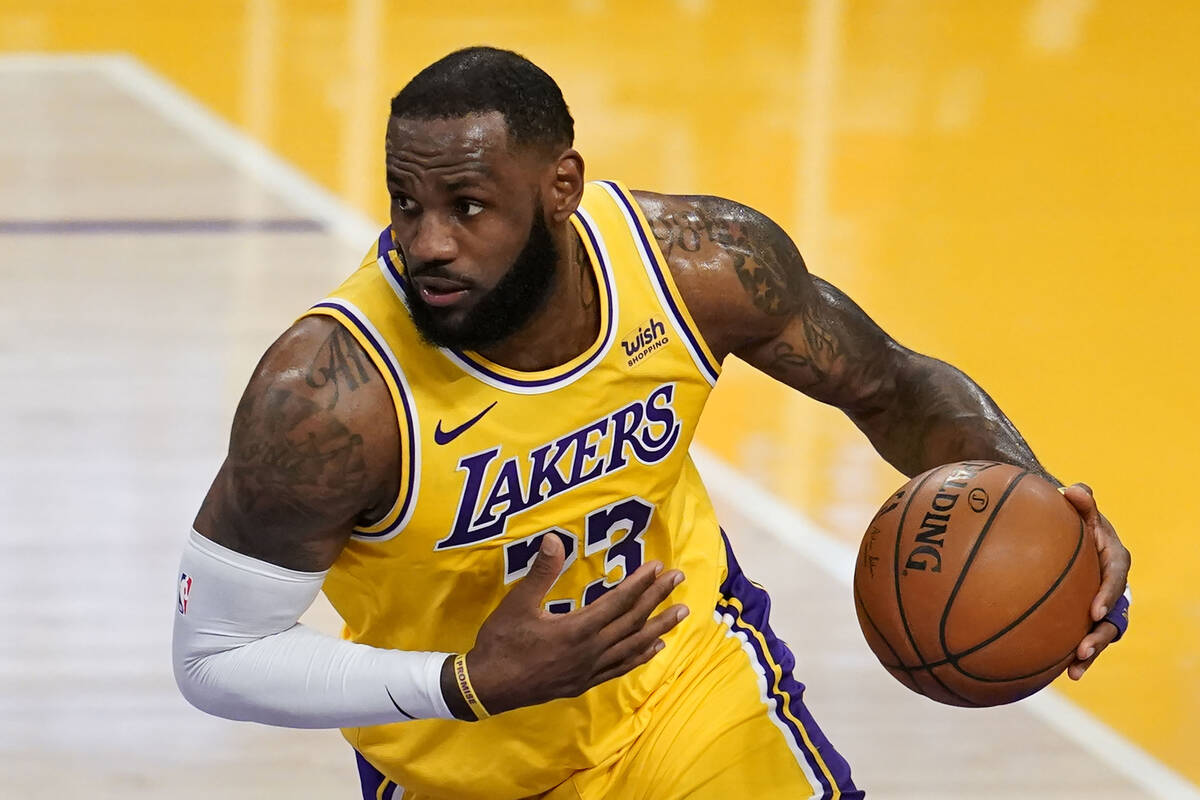 Los Angeles Lakers forward LeBron James dribbles against the Detroit Pistons during an NBA bask ...