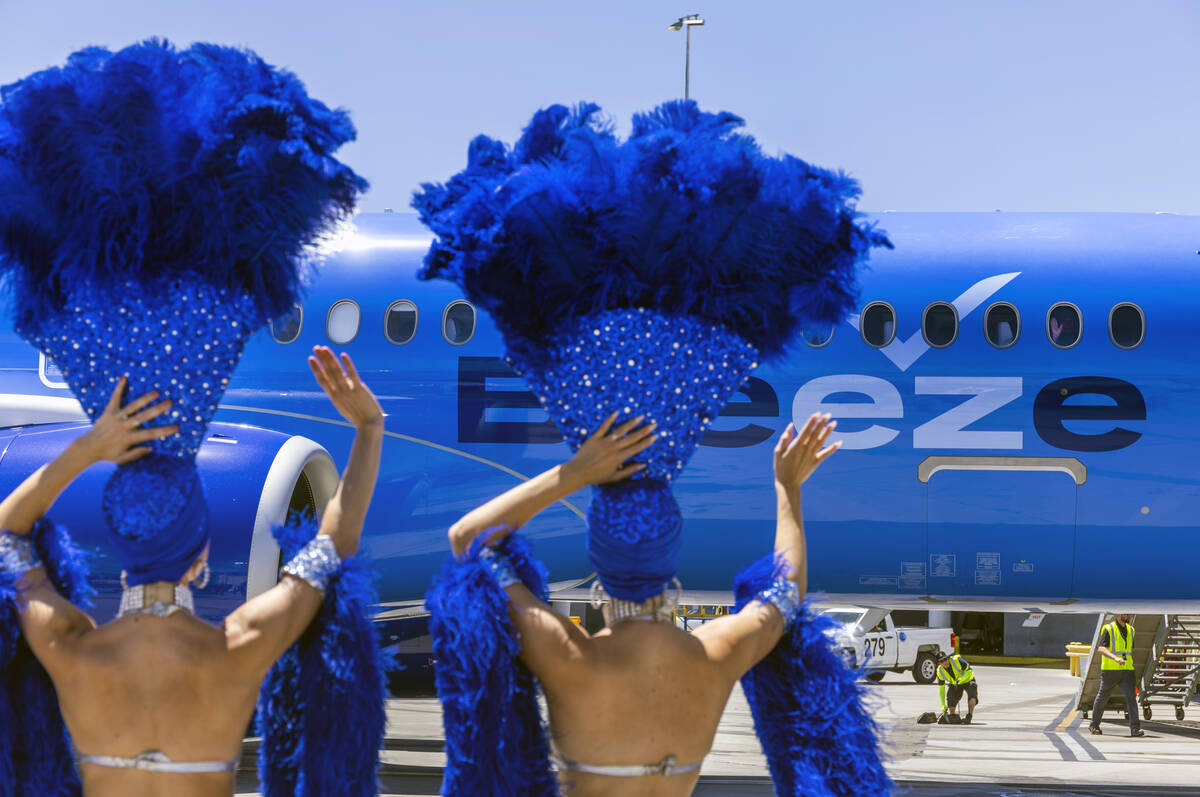 Showgirls Brooke, left, and Tara welcome passengers for the Breeze Airways inaugural flight arr ...