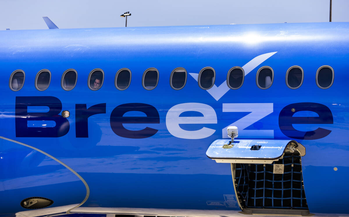 A Breeze Airways passenger looks out the window as their inaugural flight arrival makes it to t ...