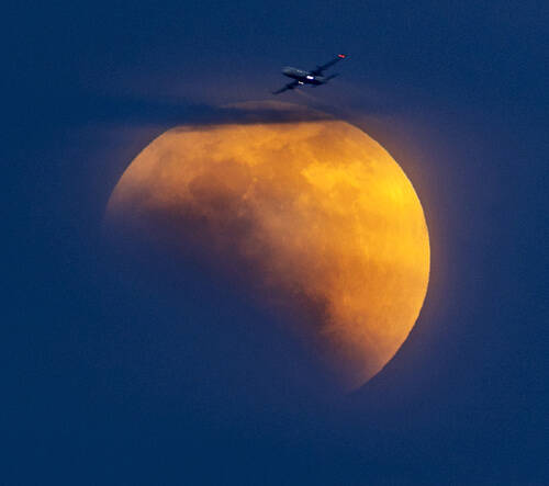 Clouds parted for a few moments to reveal the partial lunar eclipse on May 15, 2022, in Las Veg ...