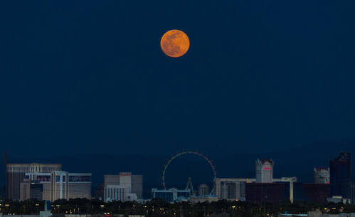 A full moon rises over the Las Vegas Strip on Tuesday, April 7, 2020. (Benjamin Hager/Las Vegas ...