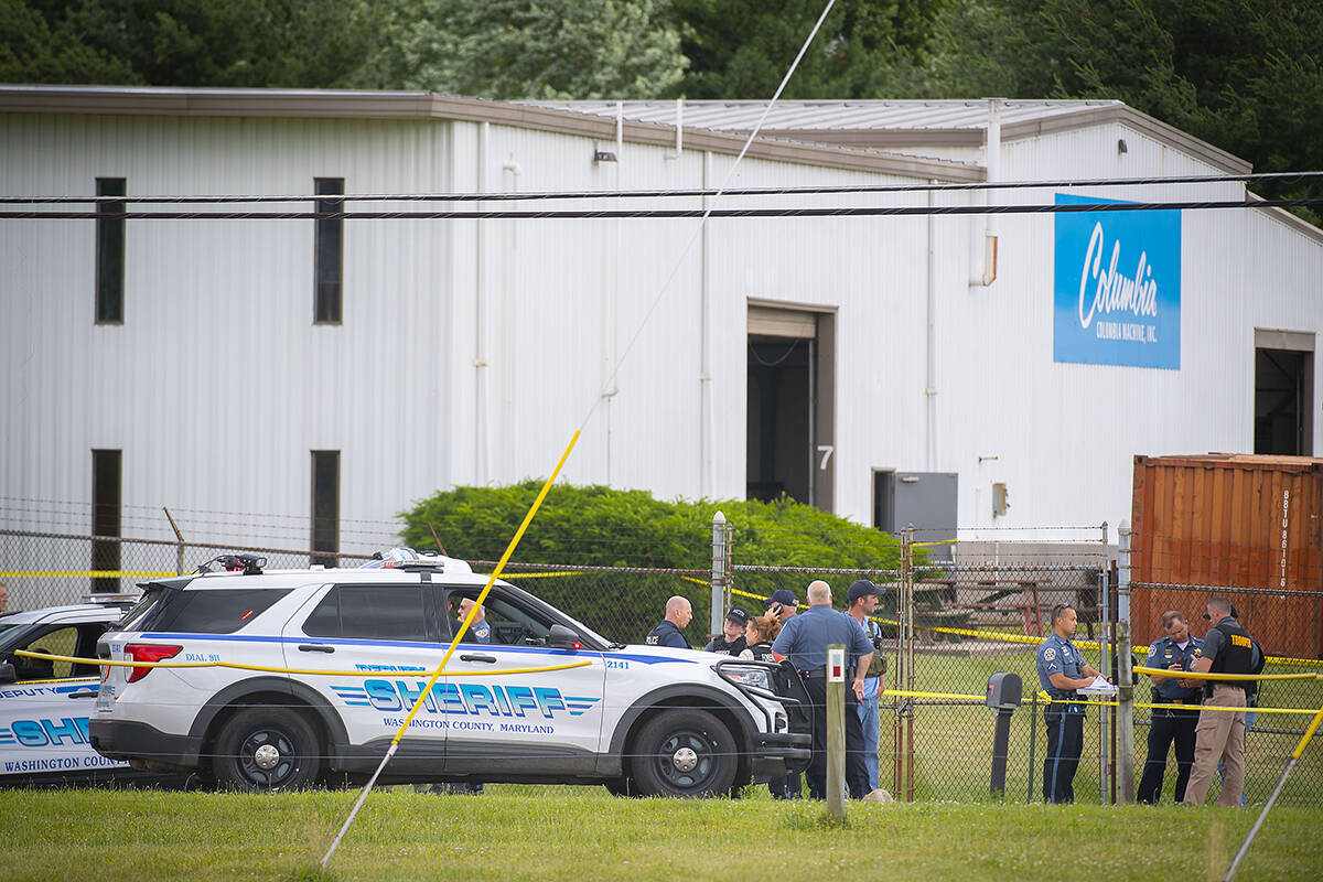 Law enforcement officials stand near the scene of a shooting at Columbia Machine, Inc., in Smit ...