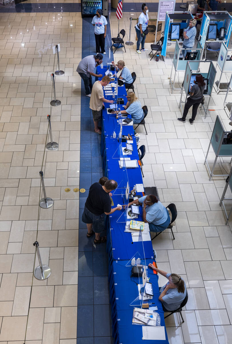 Area residents are assisted by the Clark County Election Department personnel on the last day o ...
