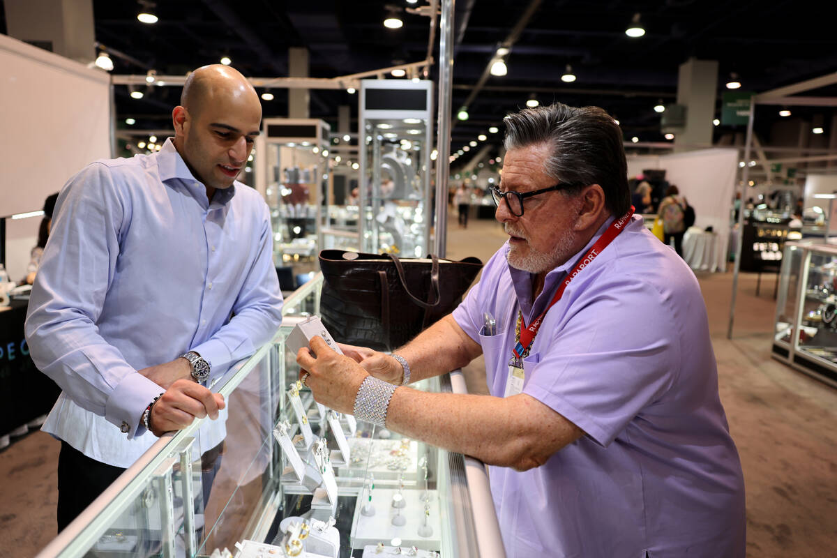 Joe “Diamond Joe” Pacetti of Dallas checks out jewelry from Justin Sachmechi of S ...