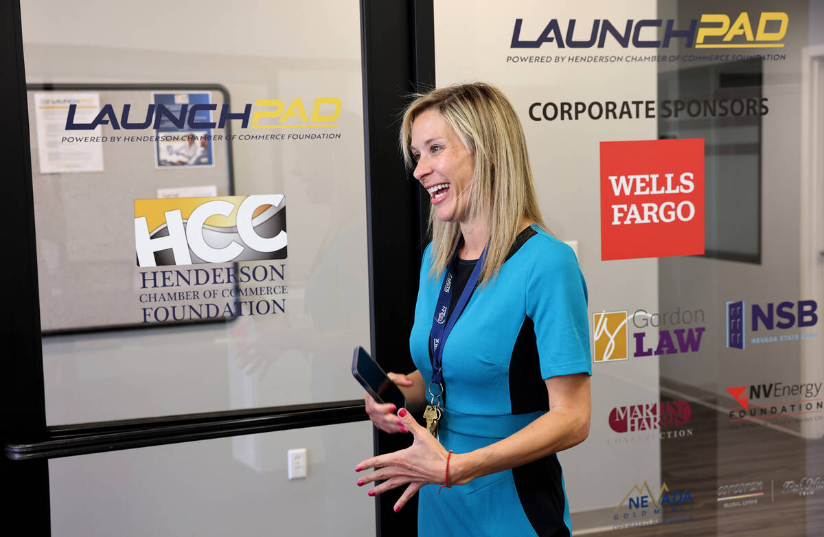 Kelly Green, executive director of the Henderson Chamber of Commerce Foundation, talks to a rep ...
