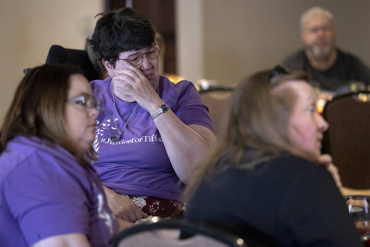 Judy Booth, mother of Tiffany Booth, cries while watching a memory video during a memorial serv ...