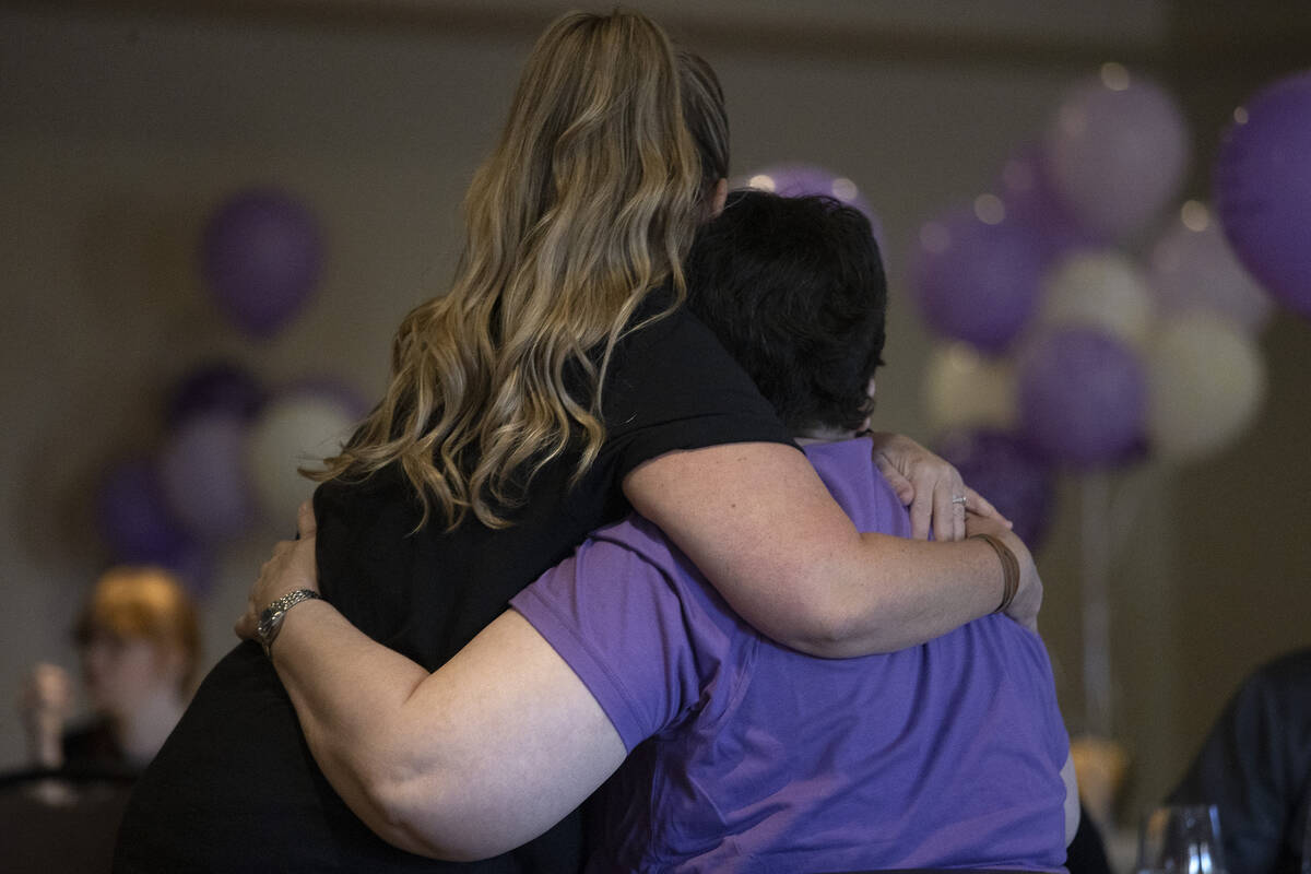 Angelena Fisher hugs Judy Booth, Tiffany Booth’s mother, during a memorial service for T ...
