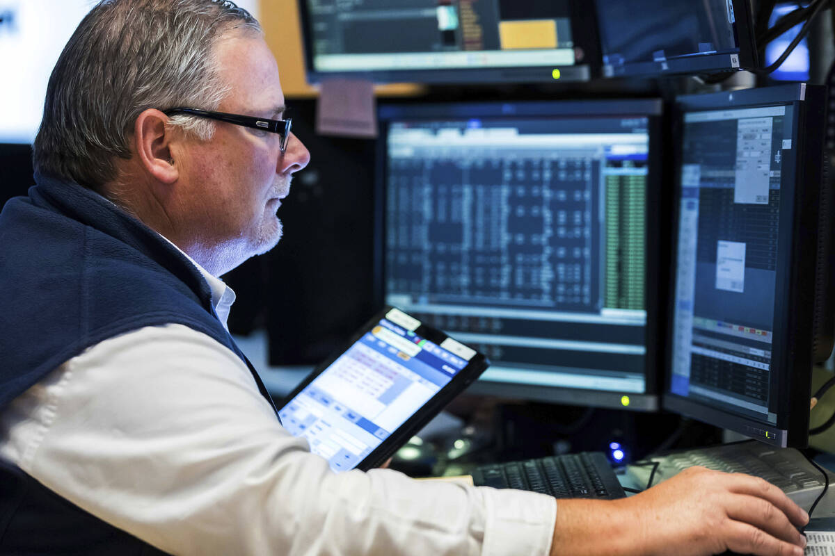 In this photo provided by the New York Stock Exchange, trader Michael Conlon works on the floor ...