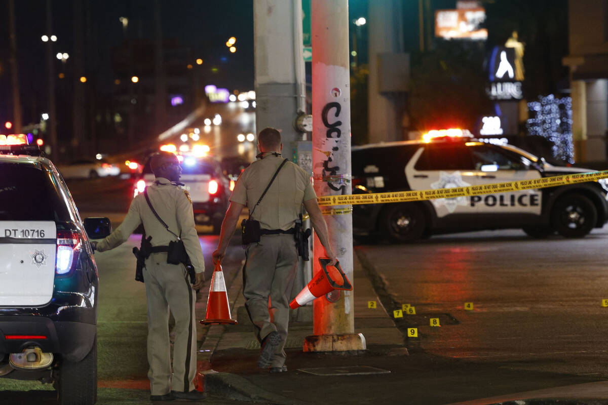 Las Vegas police investigate after a shooting near the intersection of Las Vegas Boulevard and ...
