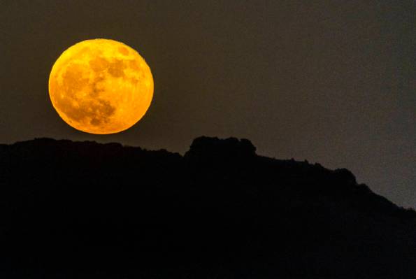 A Strawberry Supermoon rises over the city on Tuesday, June 14, 2022, in Las Vegas. (L.E. Basko ...