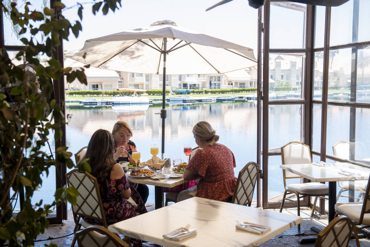 Annette Gudino, from left, Carli Medina and Ana Peña eat lunch on the lakeside patio at Ma ...