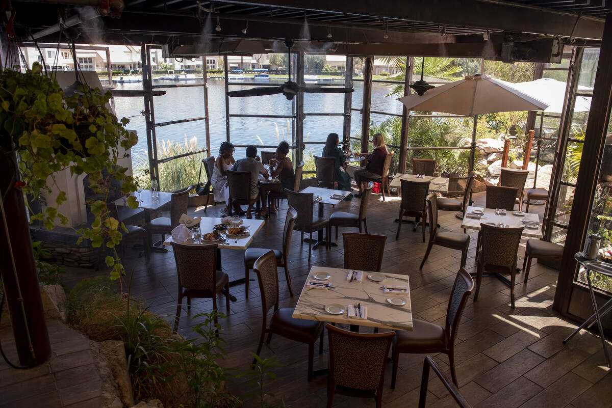 Diners eat lunch on the lakeside patio at Marché Bacchus on Wednesday, June 15, 2022, in L ...