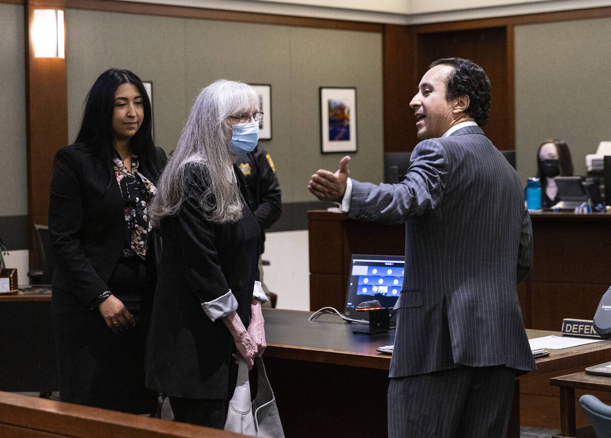 Defense attorney Mike Castillo, right, lets Linda Cooney, center, know to leave the courtroom a ...