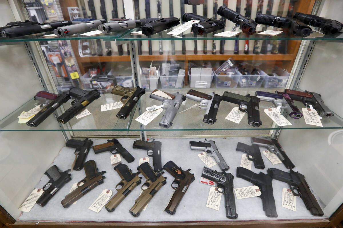 FILE - In this March 25, 2020, file photo semi-automatic handguns are displayed at shop in New ...