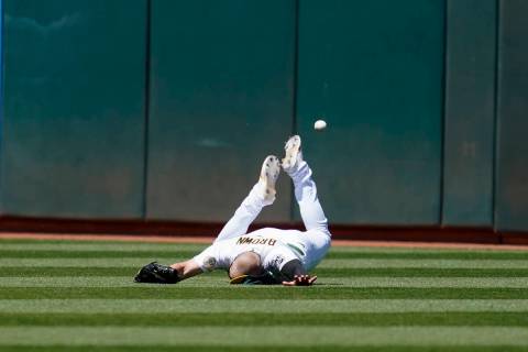 Oakland Athletics left fielder Seth Brown cannot catch a triple hit by Kansas City Royals' Mich ...