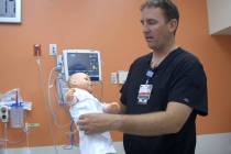 Dr. Jacob Snow, assistant medical director at Sunrise Children’s Hospital, shows a safe way t ...