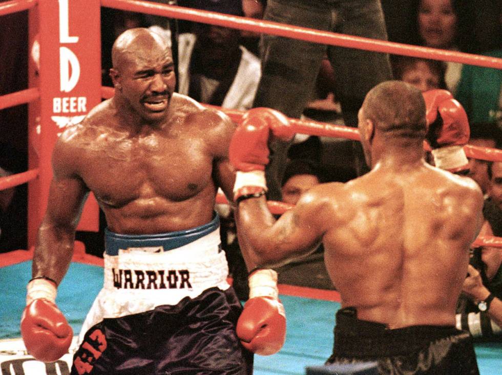Evander Holyfield comes out with a pained look on his face to meet Mike Tyson after Tyson bit o ...