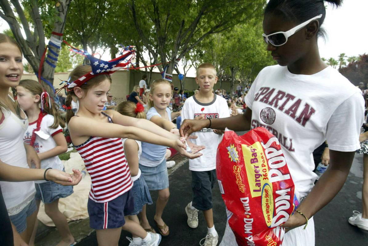 Cimarron Memorial High School student Aurelia Houston, 17, hands out candy to a group of an eag ...