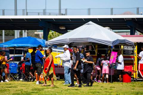 People check out vendors during a Juneteenth event held by Save Our Sons at Lorenzi Park in Las ...