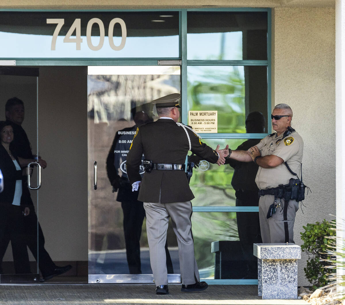 Officers greet during a public viewing for Metro Det. Justin Terry at Palm Cheyenne Mortuary wh ...