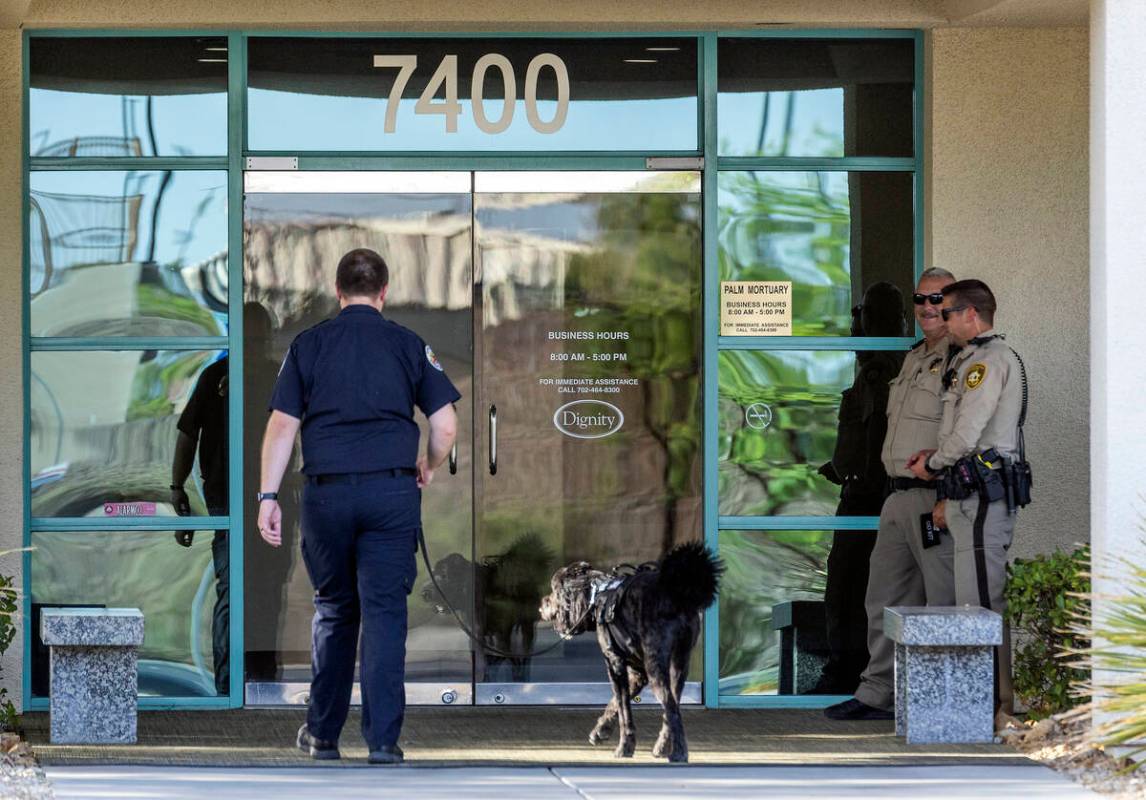A dog handler walks in as officers stand by for a public viewing for Metro Det. Justin Terry at ...