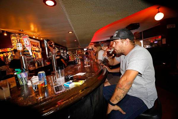 Adam Allen of Las Vegas drinks a glass of Joseph James Suave Felon #003 at Atomic Liquors, Satu ...