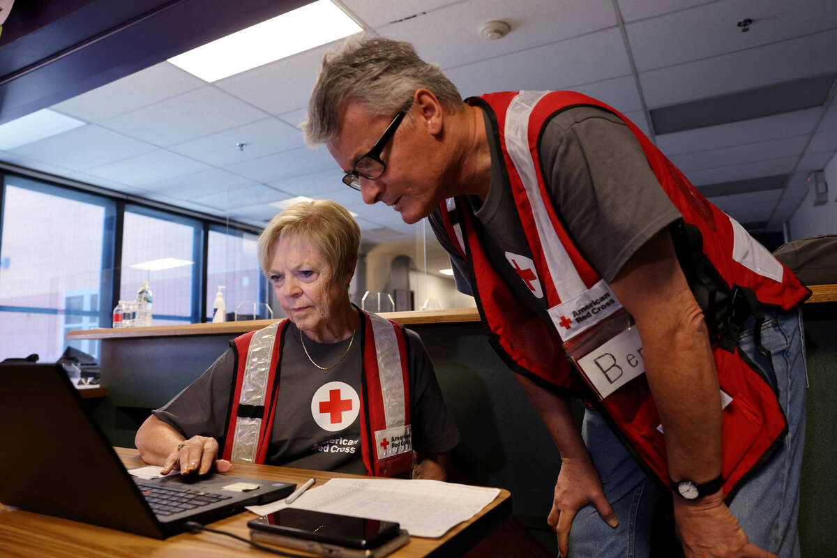 American Red Cross of Southern Nevada volunteers Diane Orgill, left, and Ben Bishop work at an ...