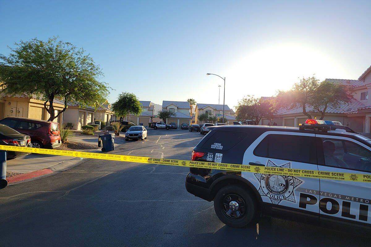 Police investigate the scene of a fatal shooting in the 6500 block of Glowing Ember Court in La ...