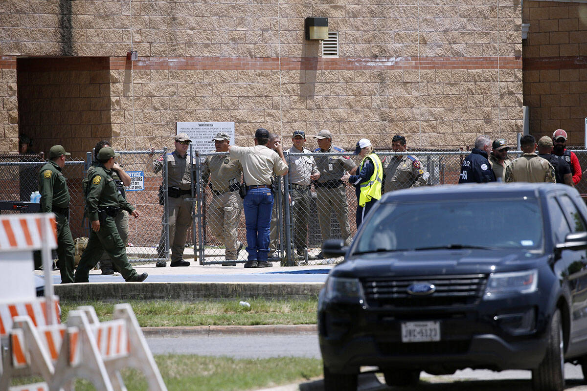 FILE - Law enforcement, and other first responders, gather outside Robb Elementary School follo ...