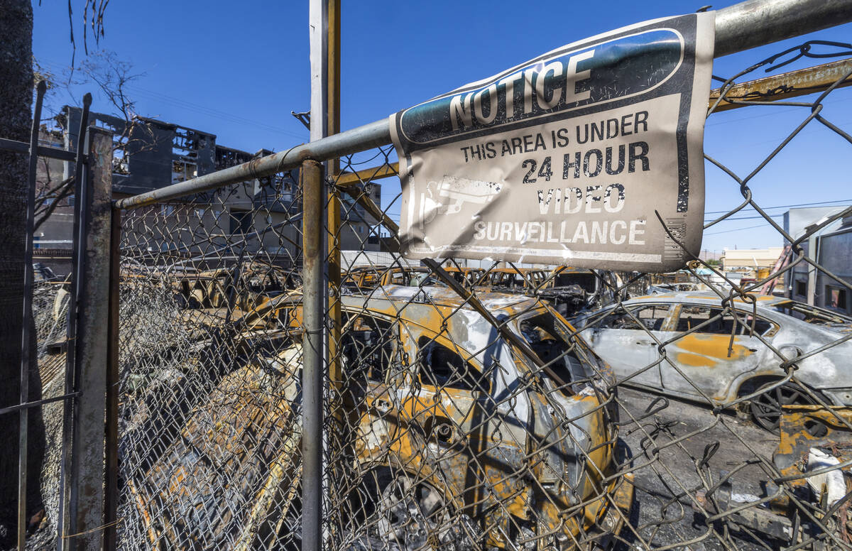 Burned out cars on the lot at Perfect Auto Body after a fire swept from stalled construction at ...