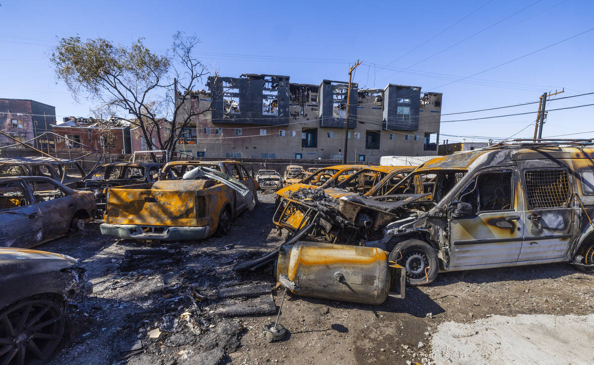 Burned out cars on the lot at Perfect Auto Body after a fire swept from stalled construction at ...