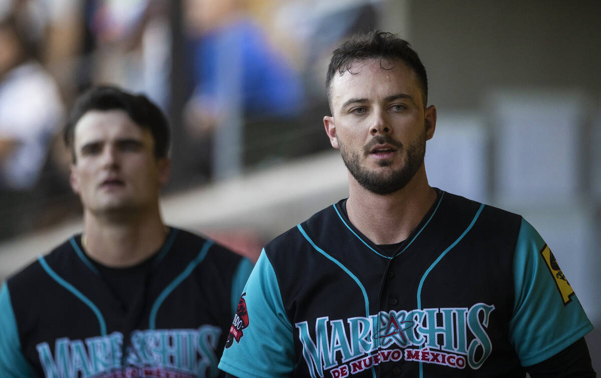 Colorado Rockies third baseman Kris Bryant, right, in the dugout during a rehab assignment with ...