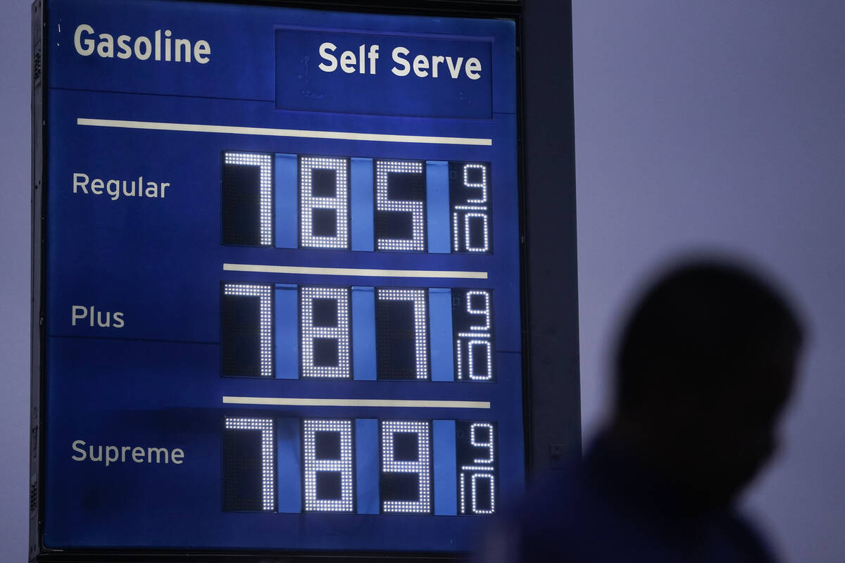 High gas prices are shown as a pedestrian waits to cross the street in Los Angeles, June 16, 20 ...