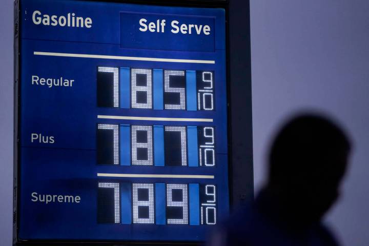 High gas prices are shown as a pedestrian waits to cross the street in Los Angeles, June 16, 20 ...