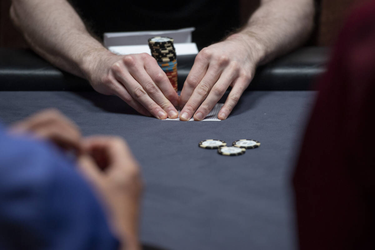 Benji Felson checks his hand during the $25,000 free roll before the start of the BetMGM Poker ...