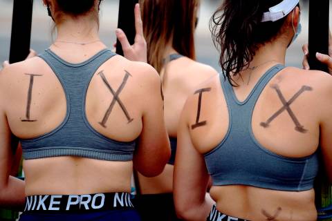 Members of the UConn women's rowing team rally about being cut by the university after the seas ...