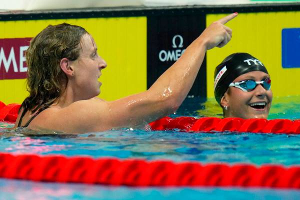 Katie Ledecky of the United States celebrates with second place Katie Grimes, right, also of th ...