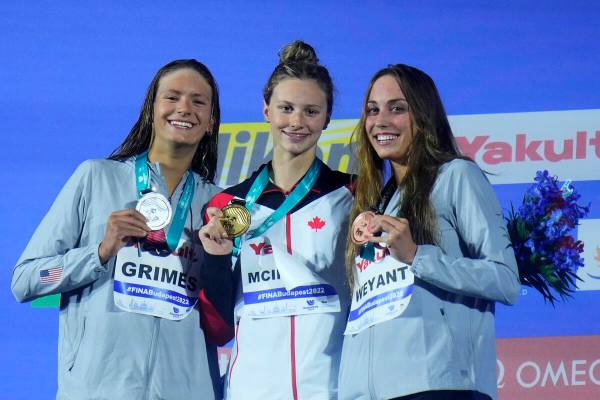 Summer McIntosh, center, of Canada, second place Katie Grimes of the United States and Las Vega ...