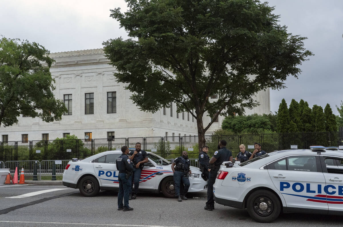 Police officers stand outside U.S. Supreme Court in Washington, Thursday, June 23, 2022. (AP Ph ...