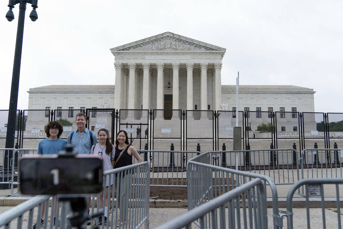 A family takes a selfie outside of the U.S. Supreme Court on Capitol Hill in Washington, Thursd ...