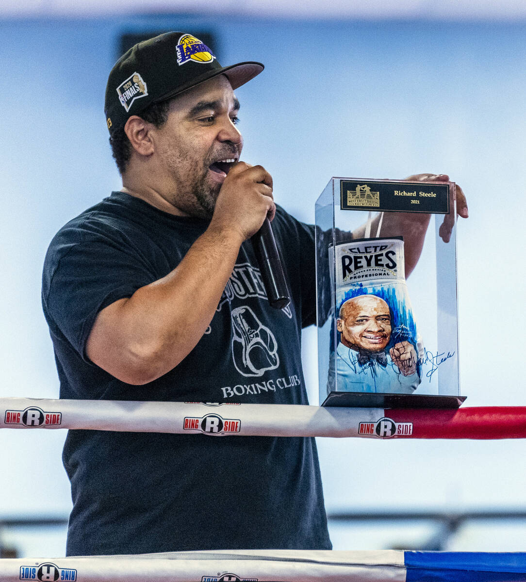 Take Pride Boxing Academy coach Percy Pride auctions off a painted glove of legendary boxing re ...