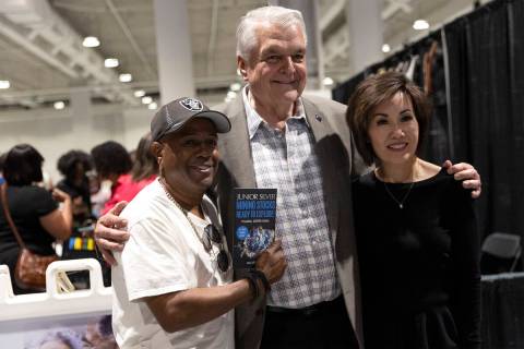 Mickey Frazier, a local author, left, poses for a photo with Gov. Steve Sisolak and his wife Ka ...