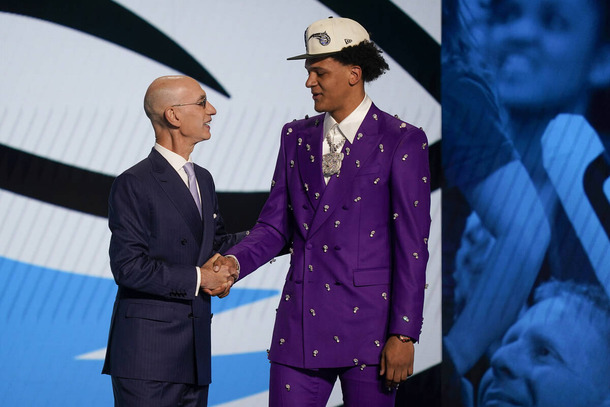 Paolo Banchero, right, is congratulated by NBA Commissioner Adam Silver after being selected as ...