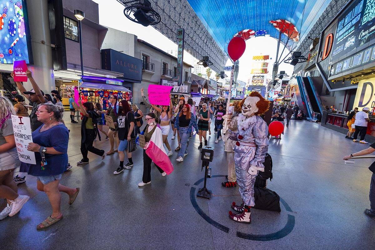 Protesters march through the Freemont Experience in response to Roe v. Wade being overturned to ...