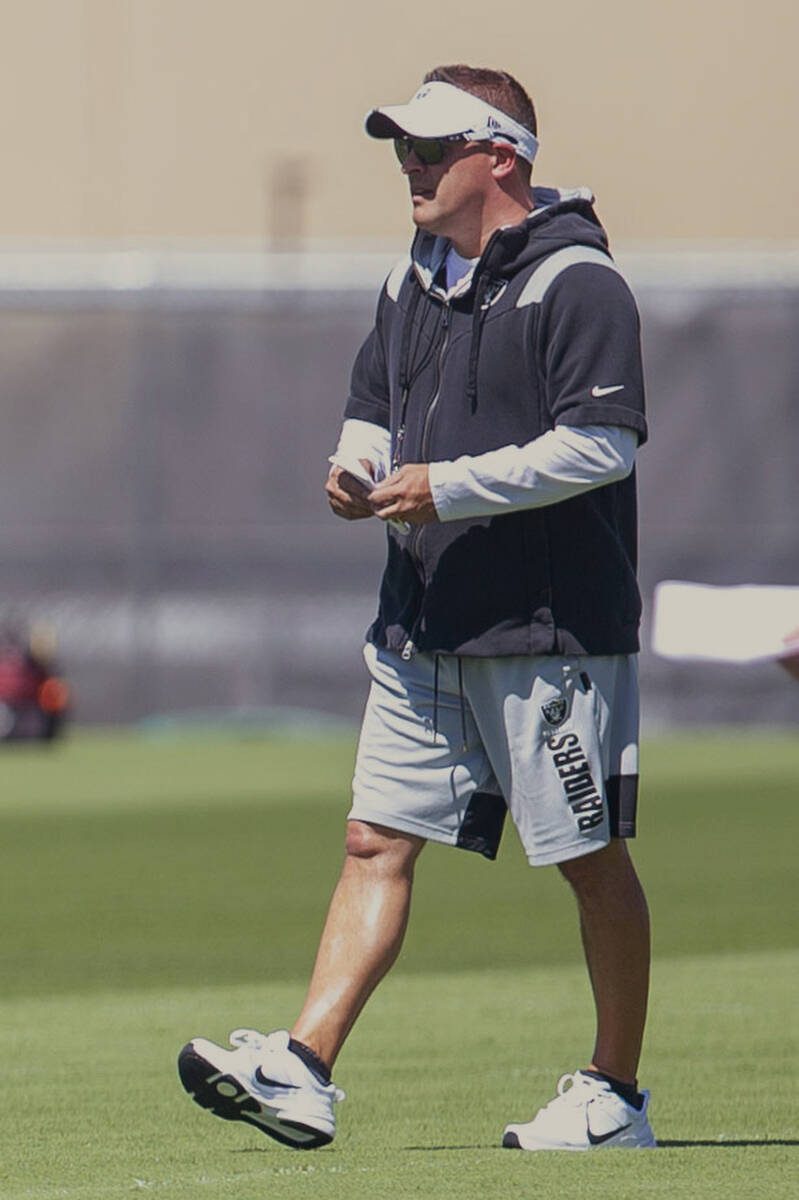 Raiders head coach Josh McDaniels walks the field during an organized training activity on Thur ...
