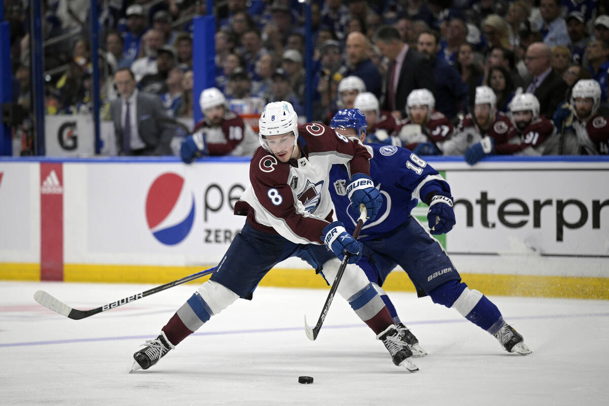 Colorado Avalanche defenseman Cale Makar (8) controls a puck in front of Tampa Bay Lightning le ...