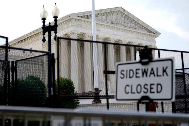 Security fencing surrounds the U.S. Supreme Court building, Monday, June 27, 2022, in Washingto ...