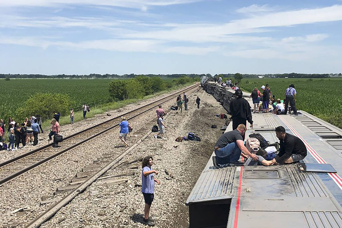 In this photo provided by Dax McDonald, an Amtrak passenger train lies on its side after derail ...