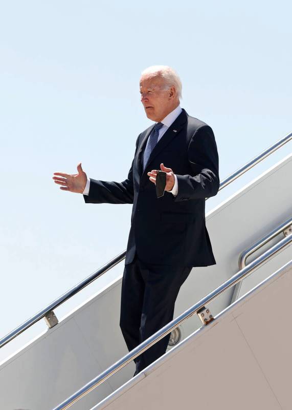 U.S. President Joe Biden walks down the steps of Airforce One on arrival at the Torreon air bas ...